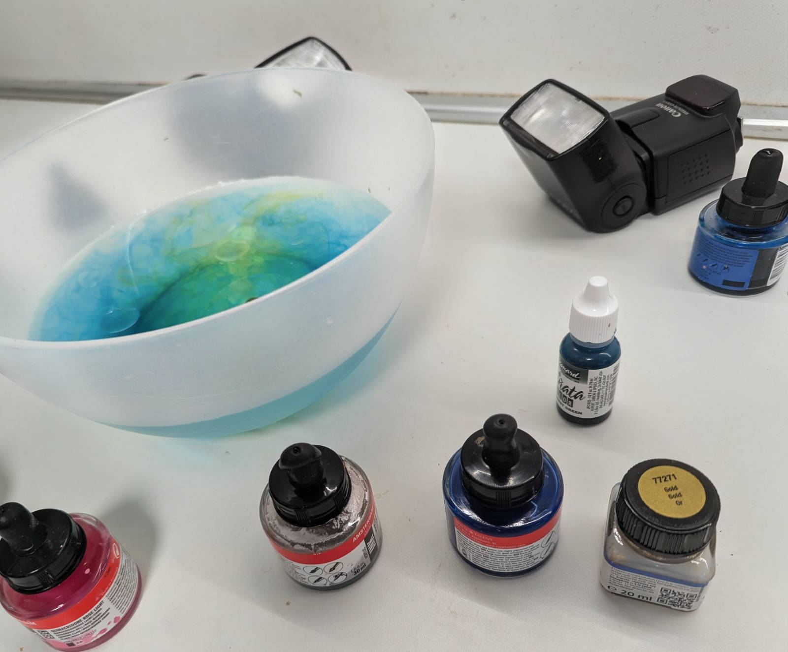 Studio workspace with inks and bowl